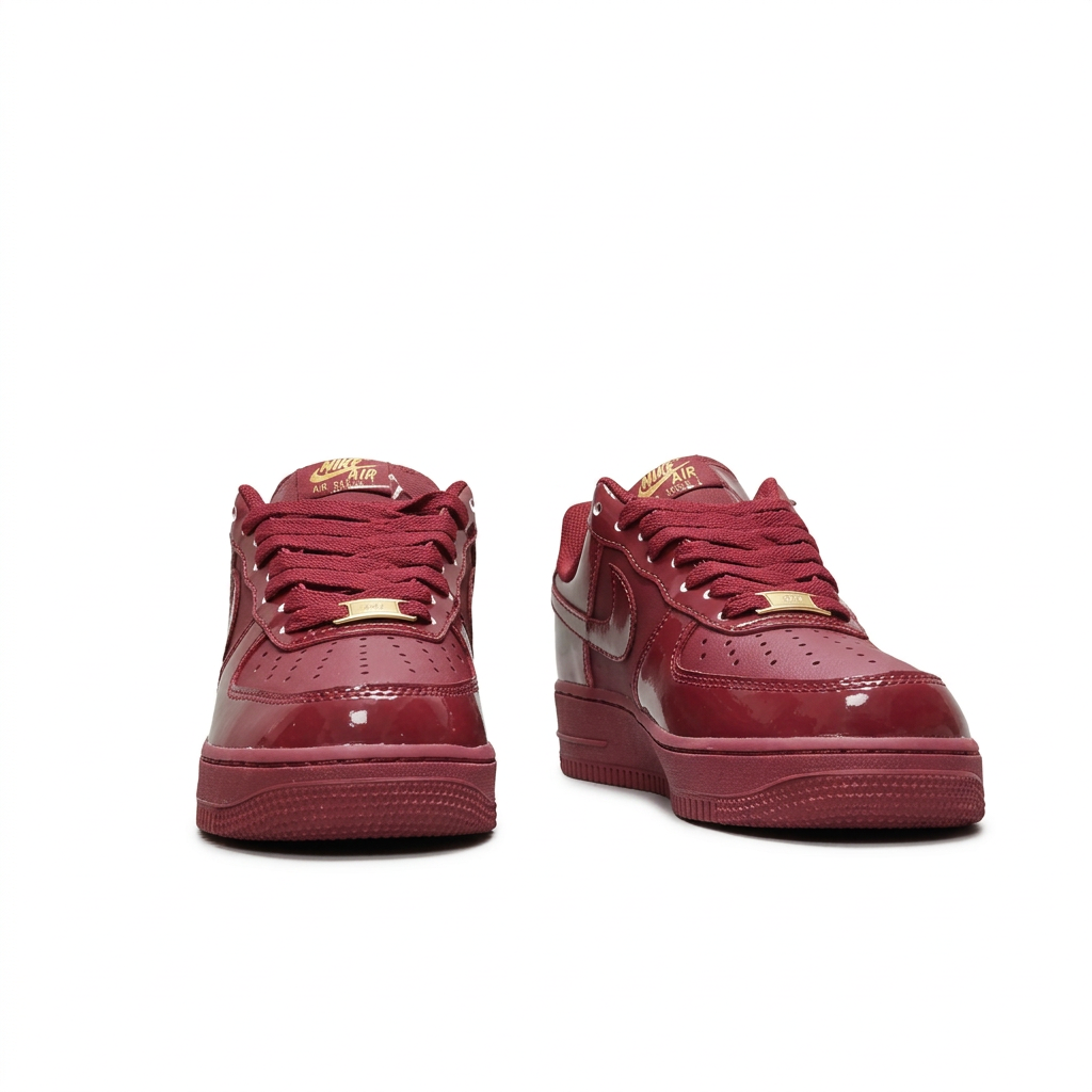Burgundy Nike sneakers with matching laces, front view on white