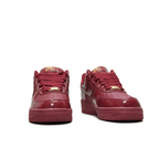 Burgundy Nike sneakers with matching laces, front view on white