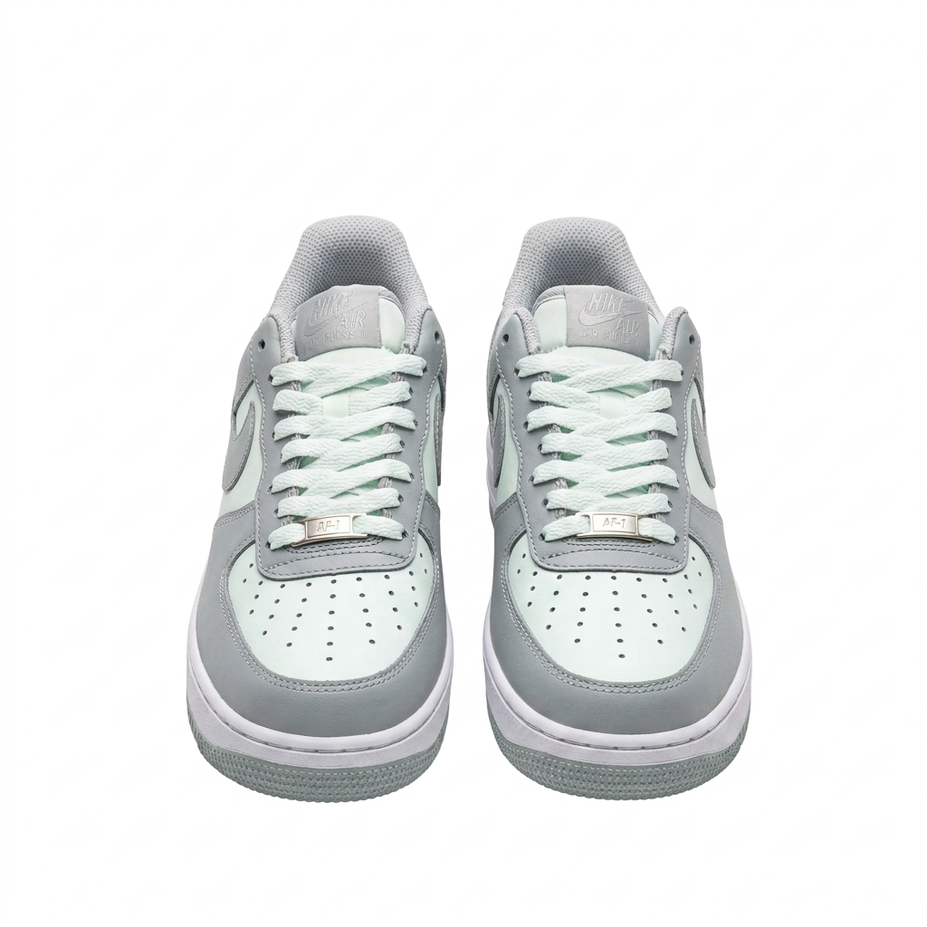 Grey and white Nike sneakers, front view on white background