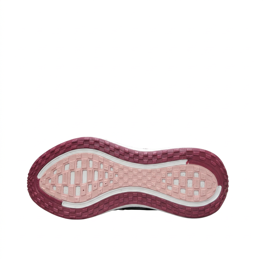 Pink and rose Nike sneaker outsole with patterned tread on white background