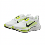 Pair of white Nike sneakers with neon lime accents, black Swoosh and thick sculpted white soles on white.