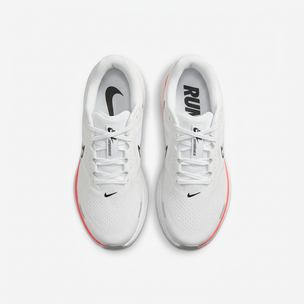 White Nike sneakers with black tongue branding, top view on white