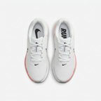 White Nike sneakers with black tongue branding, top view on white