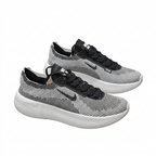 Pair of black and white textured Nike low-top sneakers with black Swoosh and thick white soles on white.