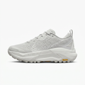 Light grey and white Nike ACG sneaker, side view on white background