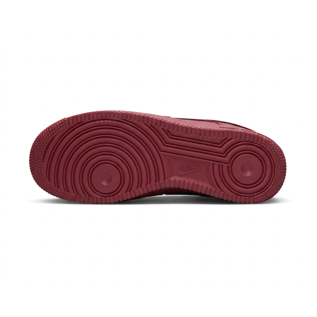 Burgundy Nike sneaker outsole with circular tread on white