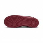 Burgundy Nike sneaker outsole with circular tread on white