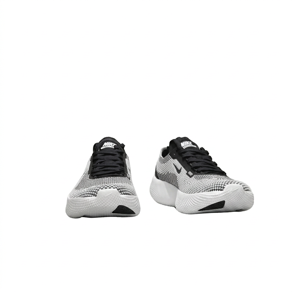 Front view of black and white textured Nike sneakers with black laces and white soles on white.