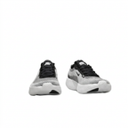 Front view of black and white textured Nike sneakers with black laces and white soles on white.