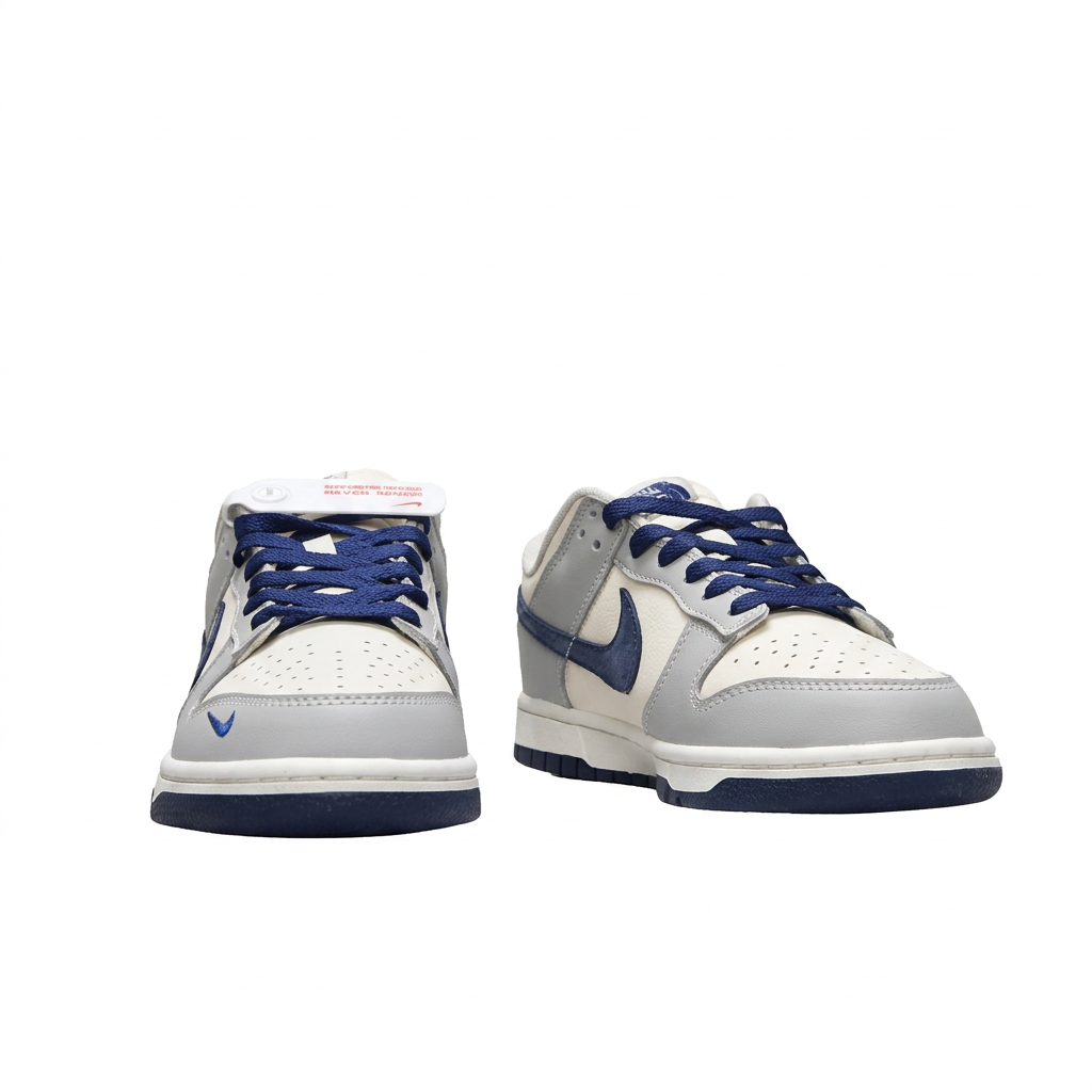 Grey white and navy Nike sneakers with navy laces, front view on white background