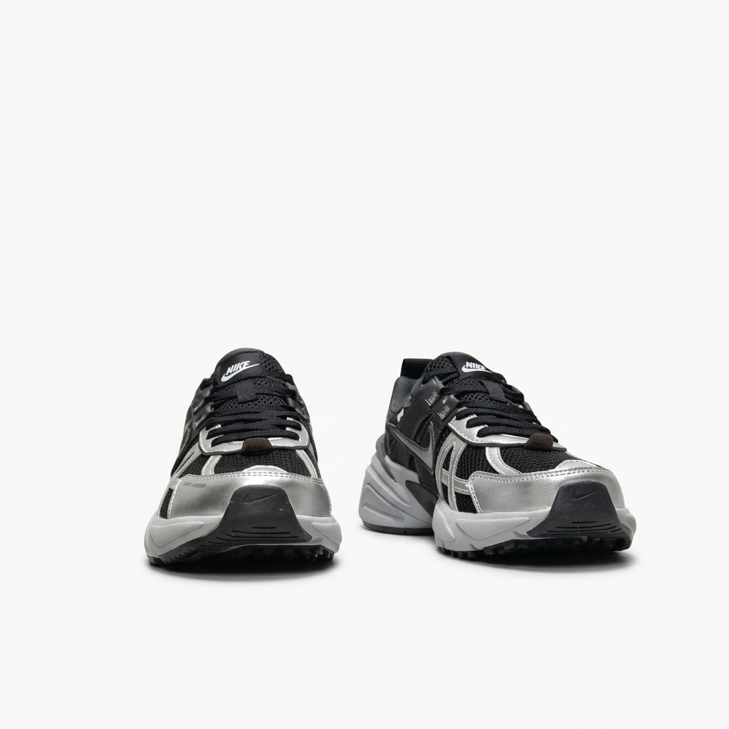 Black and silver Nike sneakers with cage-like overlays, front view on white