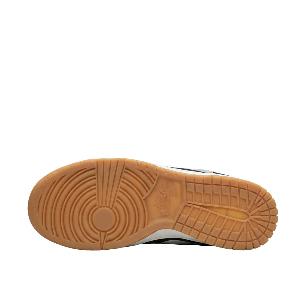 Gum-colored Nike outsole with circular forefoot tread on white background