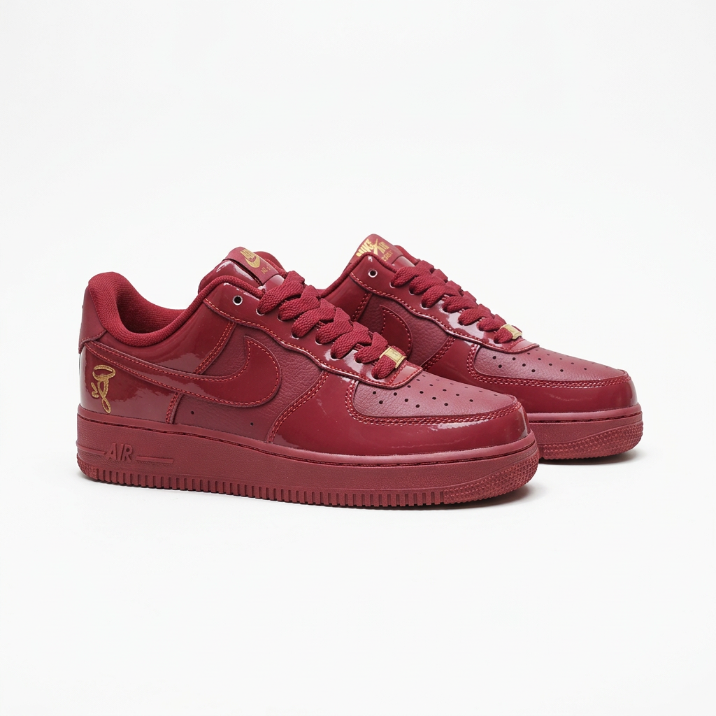 Burgundy Nike sneakers with tonal Swooshes, angled view on white