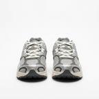 Silver grey Nike mesh sneakers with white laces, front view on white