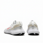 Rear view of white Nike sneakers with pale heel panels on white background
