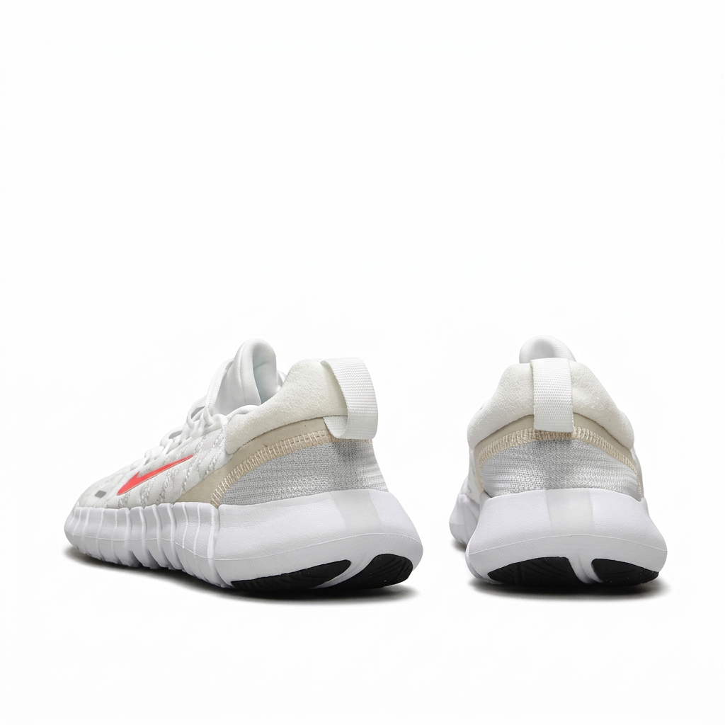 Rear view of white Nike sneakers with pale heel panels on white background