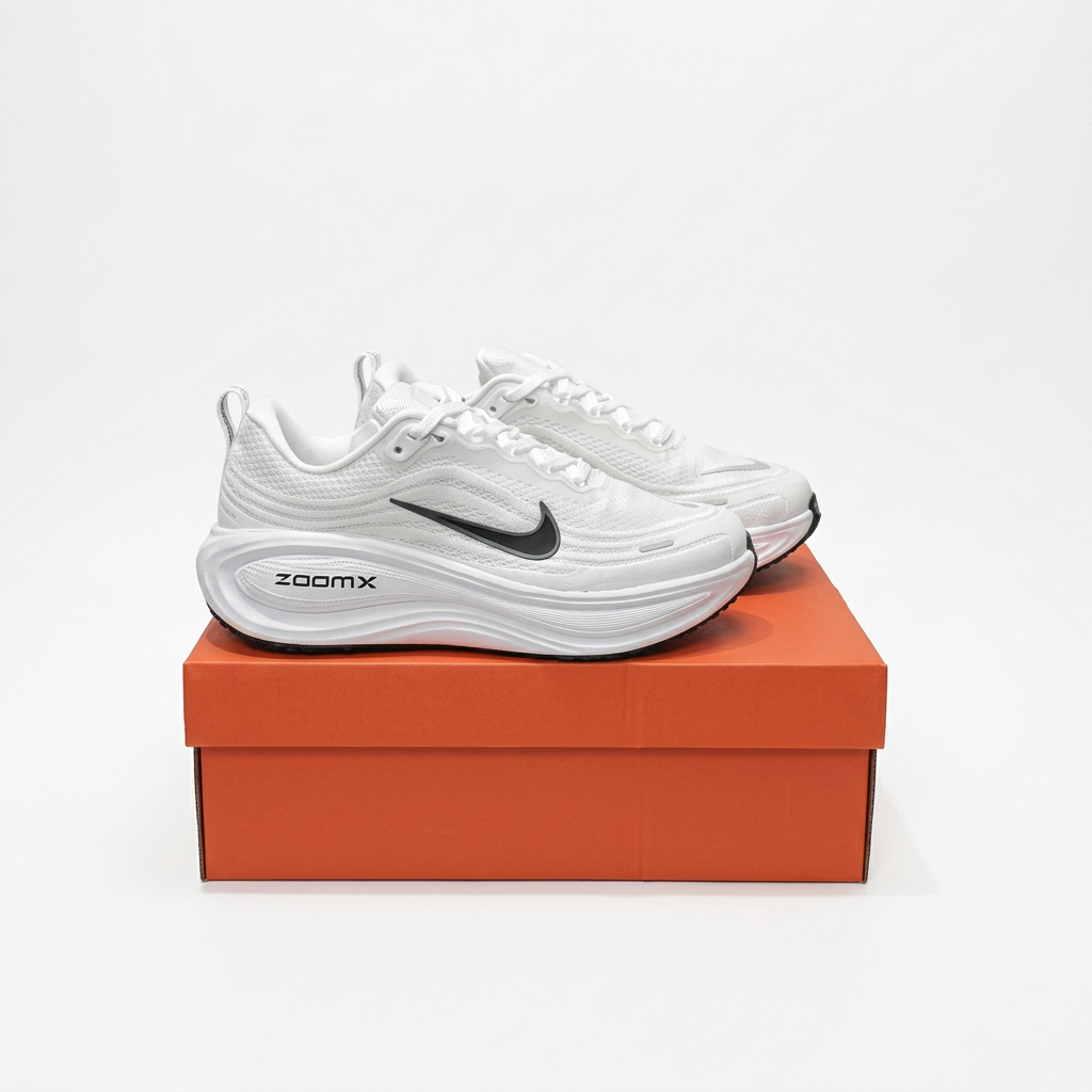 White Nike ZoomX low-top sneakers on an orange shoe box