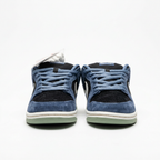 Front view of the Nike navy blue and black suede low-top sneakers