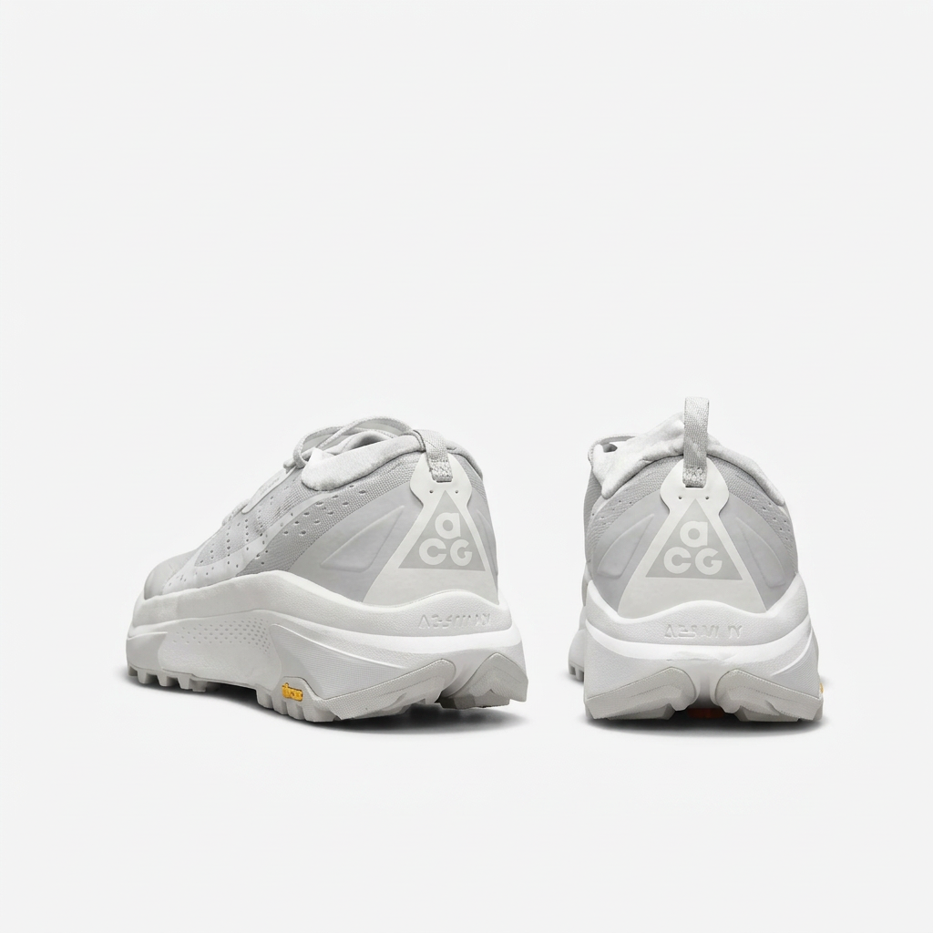 Light grey and white Nike ACG sneakers, rear view on white background