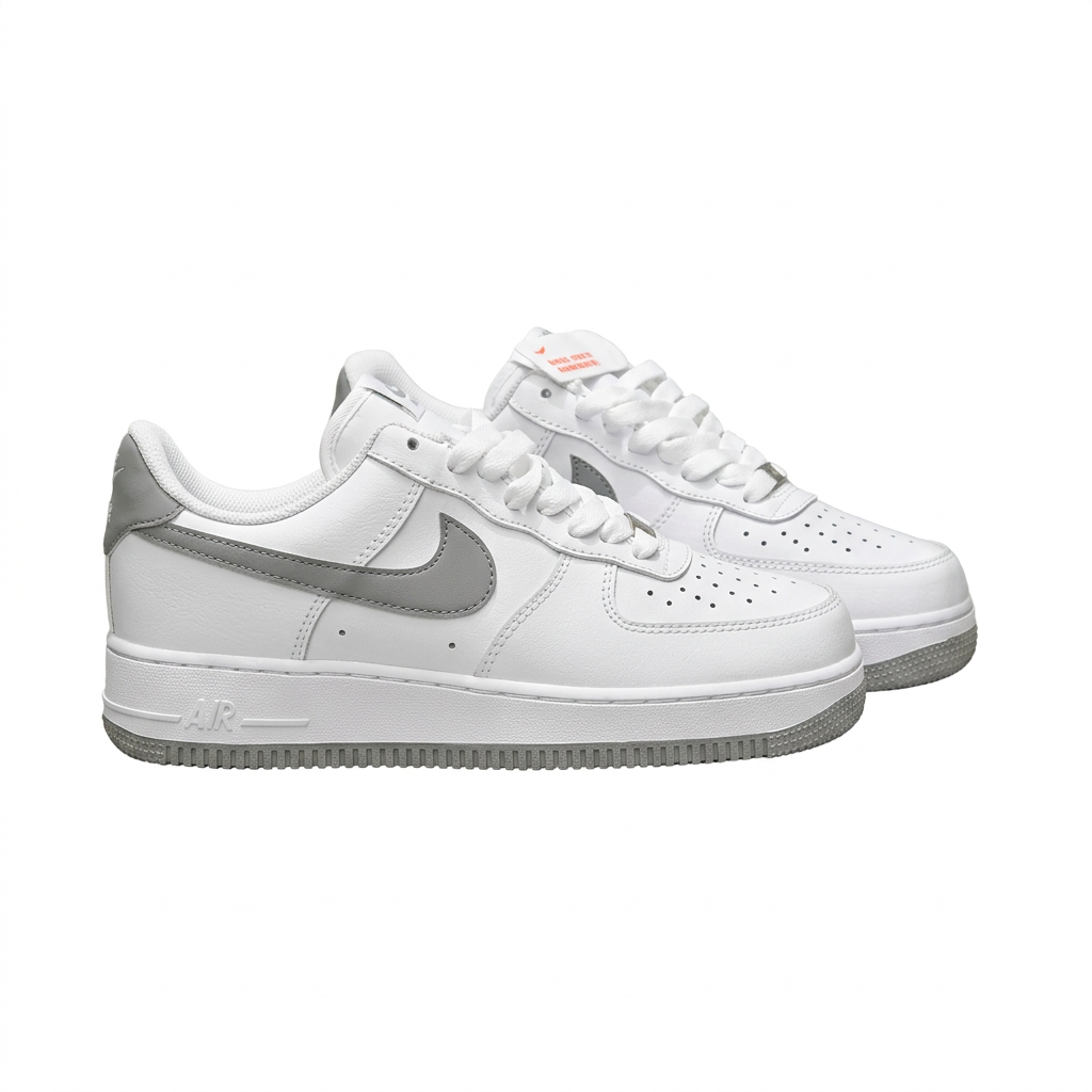 White and grey Nike Air Force 1 sneaker pair, angled view on white background