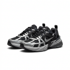 Black and metallic silver Nike chunky sneakers, angled view on white background
