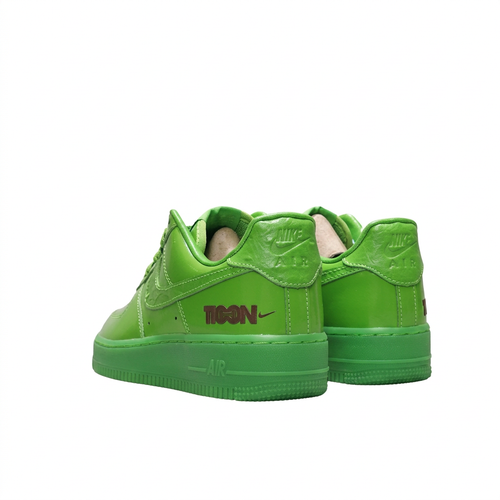 Bright green Nike Air Force 1 sneakers with Nike Air heel branding, rear angled view on white background