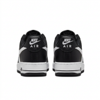 Rear view of black and white Nike sneakers with Nike Air heel branding on white.
