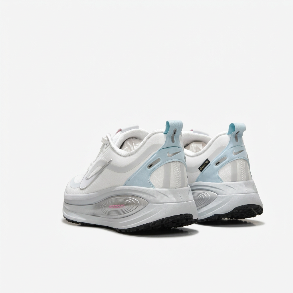White Nike sneakers with ice-blue heel tabs, rear view on white background