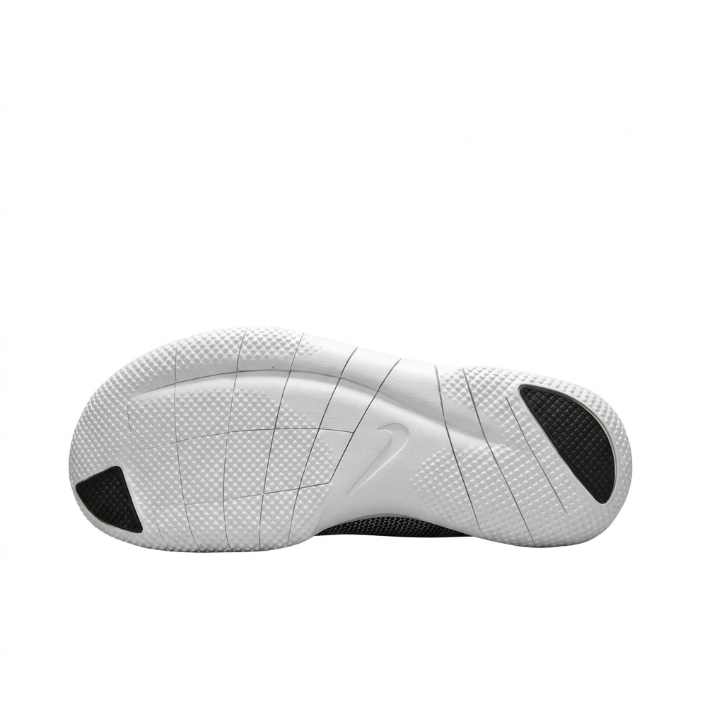 White sneaker outsole with segmented grooves and black toe and heel sections on white.