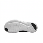White sneaker outsole with segmented grooves and black toe and heel sections on white.
