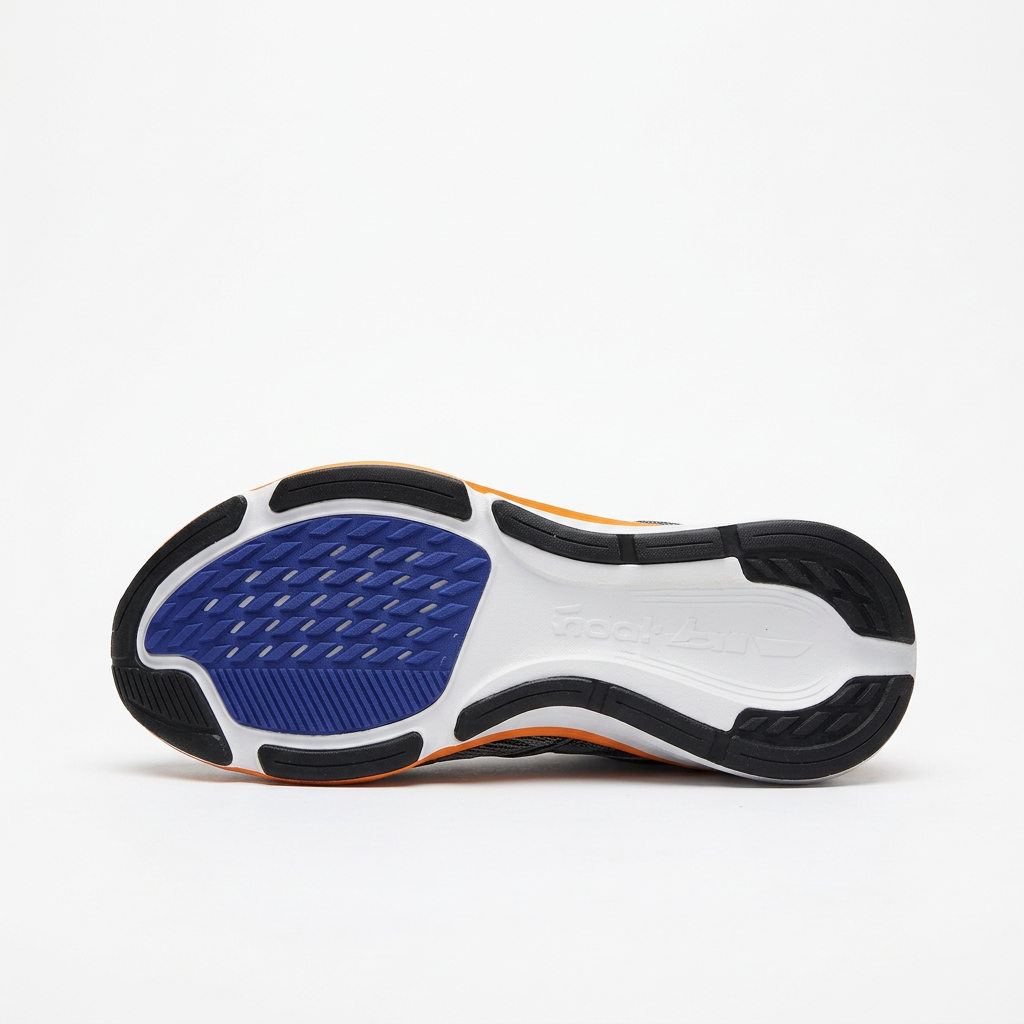 Black outsole with navy tread pod of the white and navy Nike low-top sneaker