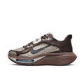Left-facing dark brown and taupe Nike sneaker with charcoal Swoosh and blue forefoot window on white.