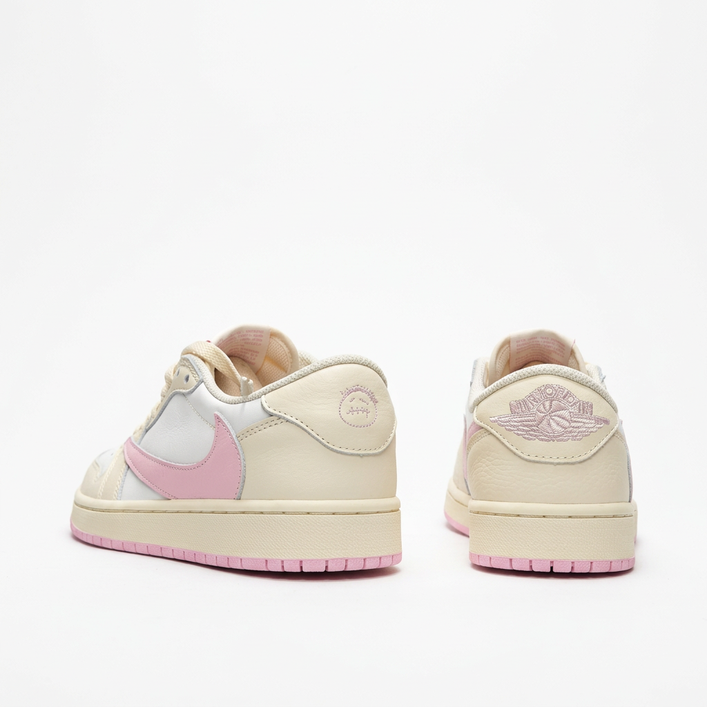 Cream and pink low-top sneakers with embroidered heels, rear view on white