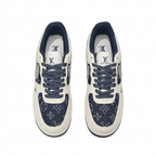 Top view of cream and navy patterned low-top sneakers with navy speckled laces on white.