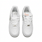 White Nike Air Force 1 sneakers with white laces and perforated toes, overhead view on white background