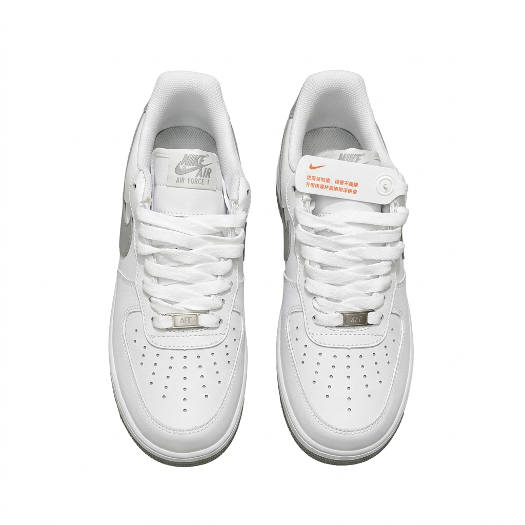 White Nike Air Force 1 sneakers with white laces and perforated toes, overhead view on white background