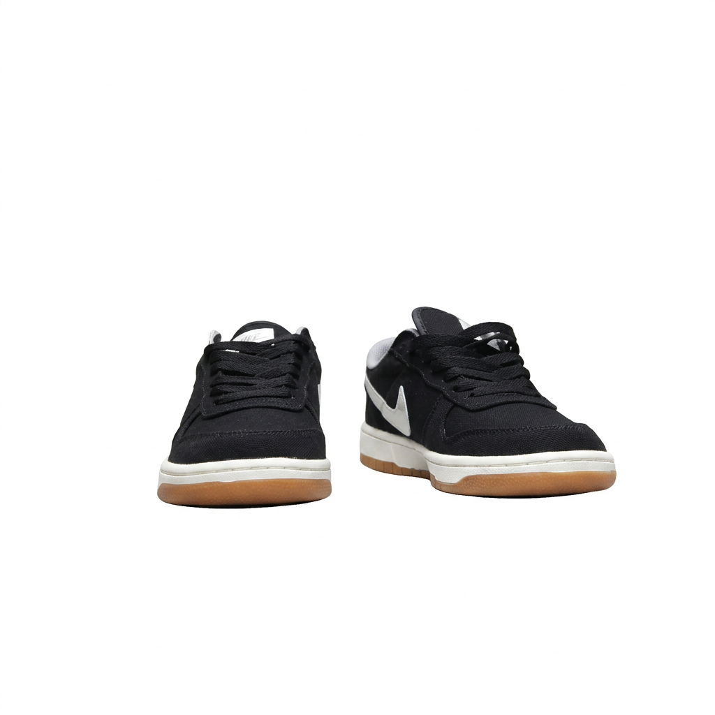 Black Nike sneakers with white midsoles and gum outsoles, front view on white background