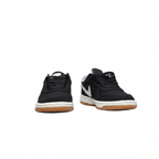 Black Nike sneakers with white midsoles and gum outsoles, front view on white background