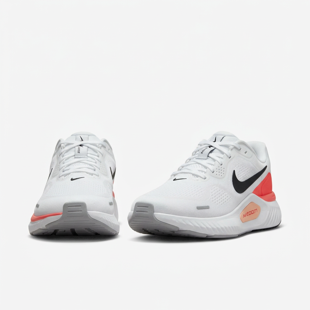 White Nike sneakers with white laces and coral accents, front view on white