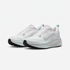 White Nike sneakers with sculpted soles and ice-blue accents, angled view on white background