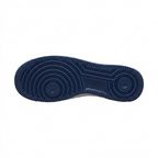 Navy sneaker outsole with circular tread patterns on a white background.