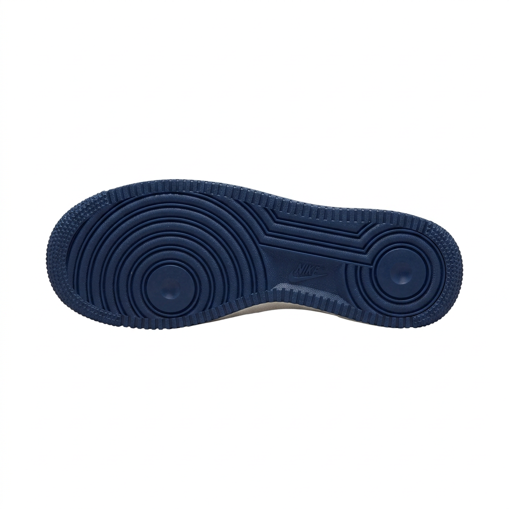 Navy sneaker outsole with circular tread patterns on a white background.