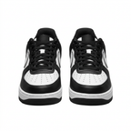 Front view of black and white Nike sneakers with black laces and perforated white toes on white.