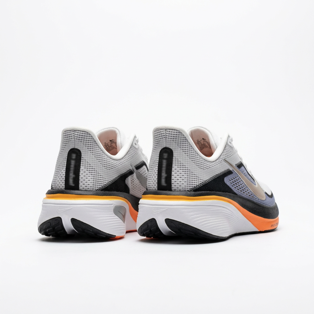Heel view of the white and navy Nike low-top sneakers
