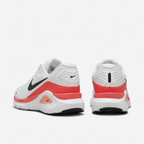 White Nike sneakers with coral-red heel bands, rear view on white