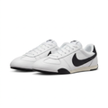 Pair of white Nike sneakers with large black Swoosh details and cream-toned midsoles on white.