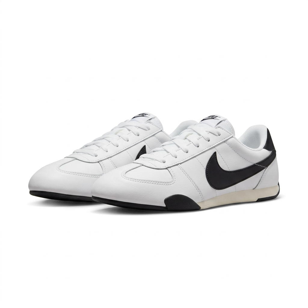 Pair of white Nike sneakers with large black Swoosh details and cream-toned midsoles on white.