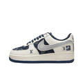 Left-facing cream and navy patterned Nike low-top sneaker with grey Swoosh on white.
