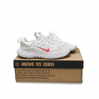 White Nike sneakers with pink Swooshes displayed on brown shoebox on white background