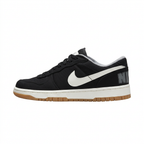 Black Nike sneaker with white Swoosh and gum-colored outsole, side view on white background